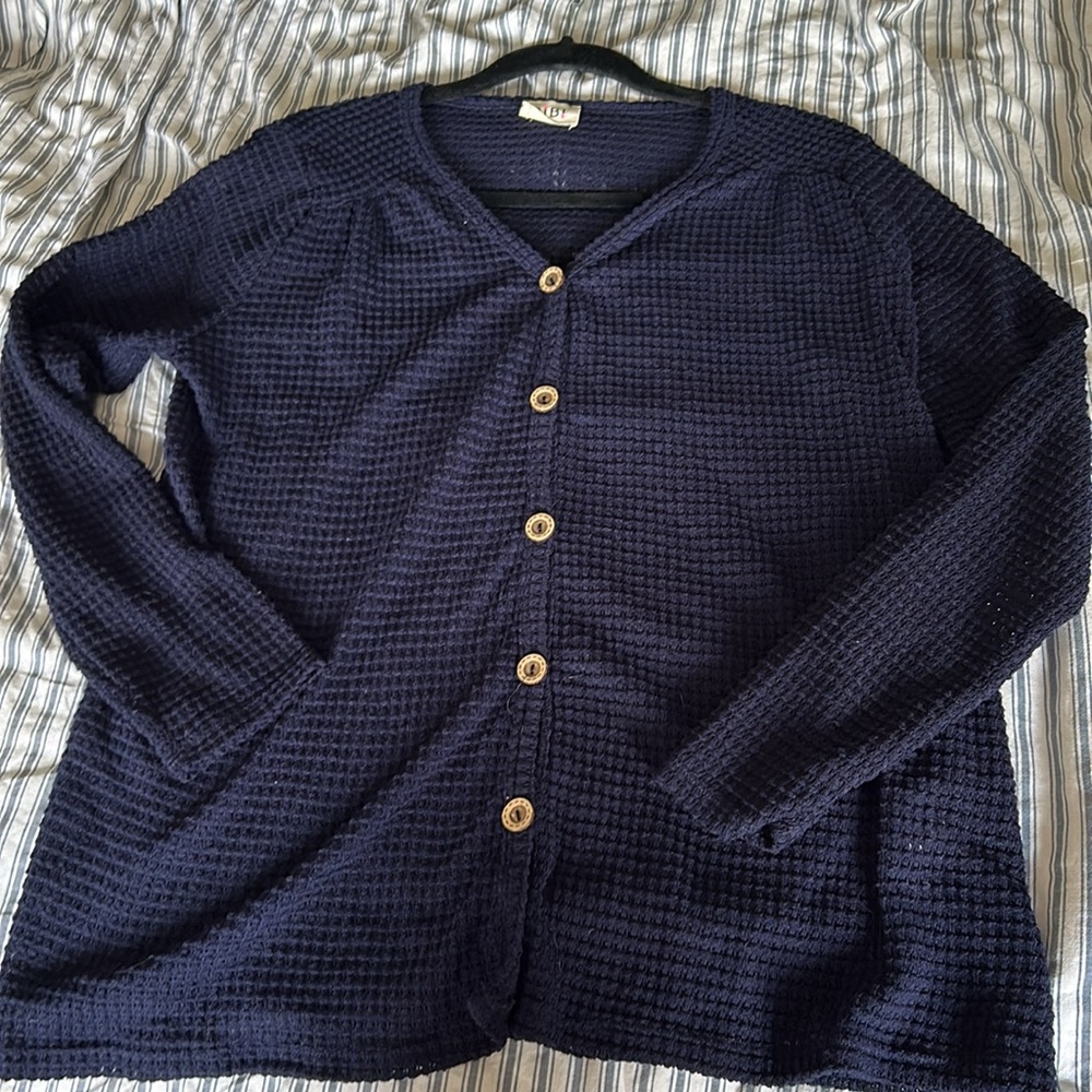 Bibi open work top with vneck and long sleeves. Button are fixed